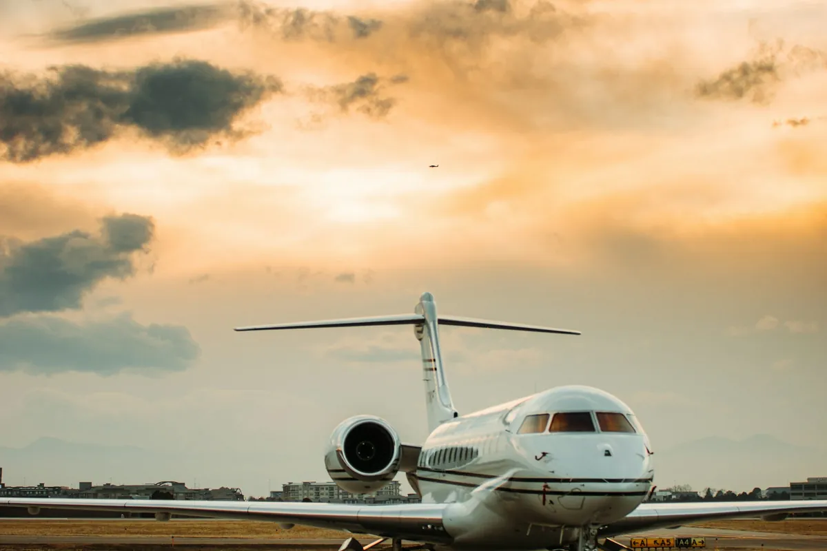 Business jet on the tarmac at sunset